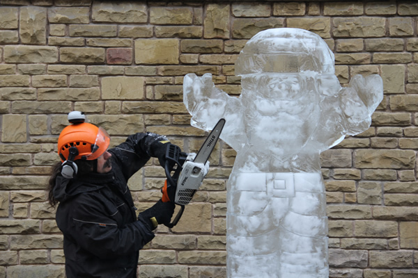 chainsaw carving an ice Santa Claus