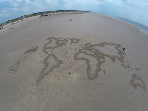 sand drawing of a map of the world