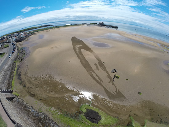 Anamorphic sand drawing from the air
