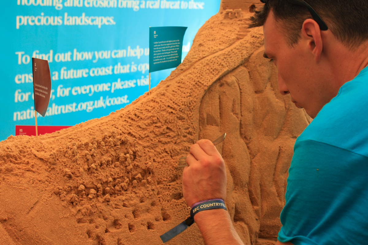Tom working on the sand sculpture at Countryfile Live Festival with the National Trust