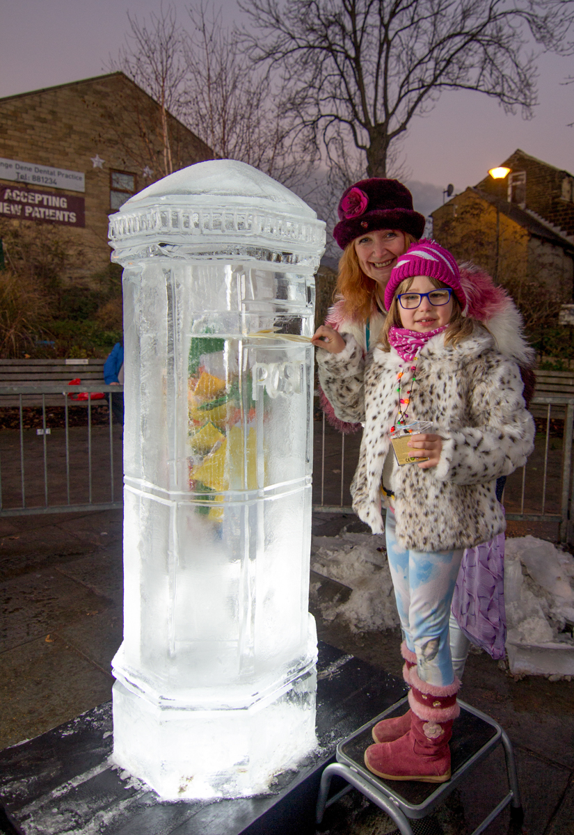 children posting their letters to Santa in the ice post box